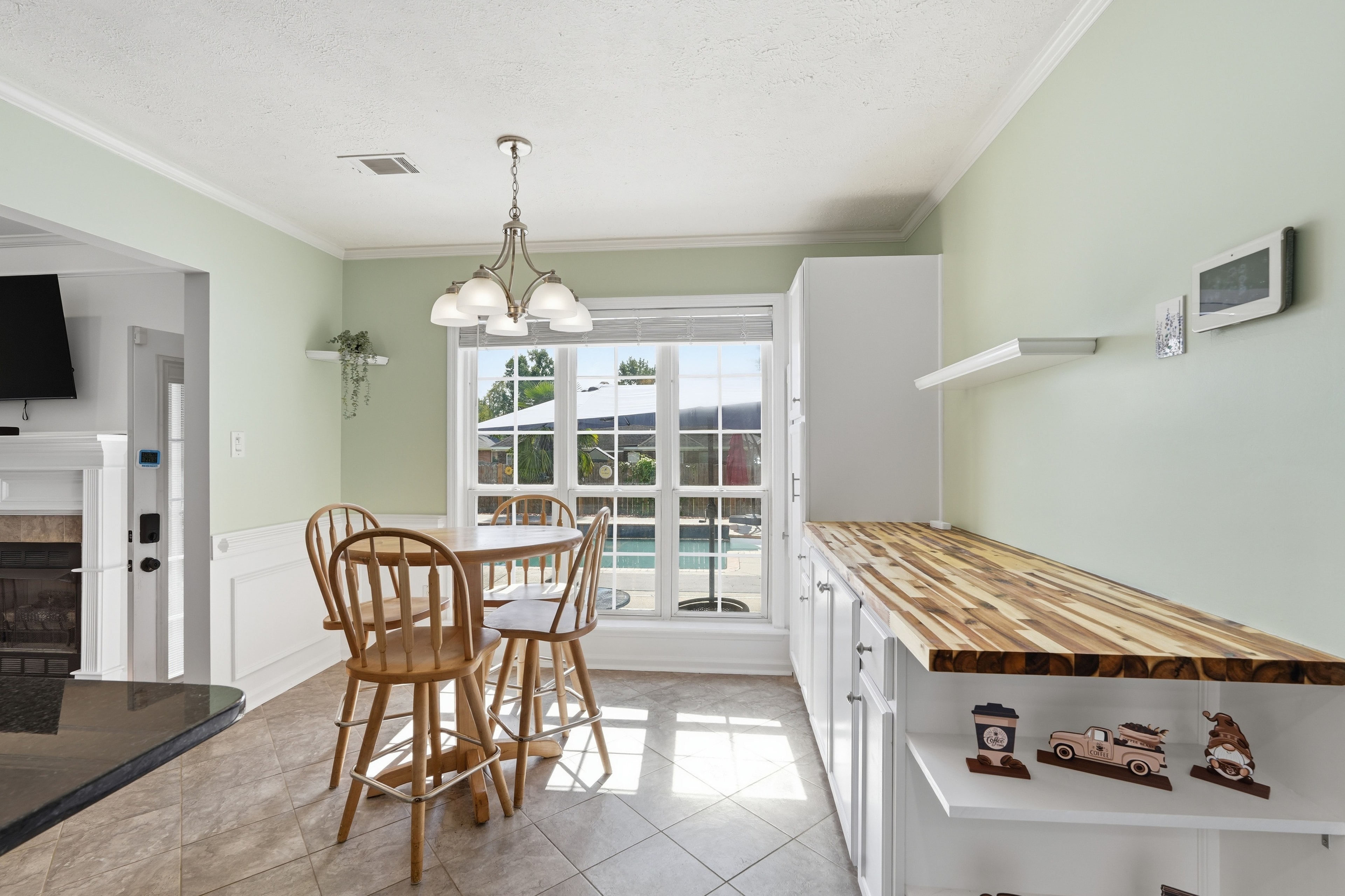 Breakfast nook with a butcher block counter and a window to the pool